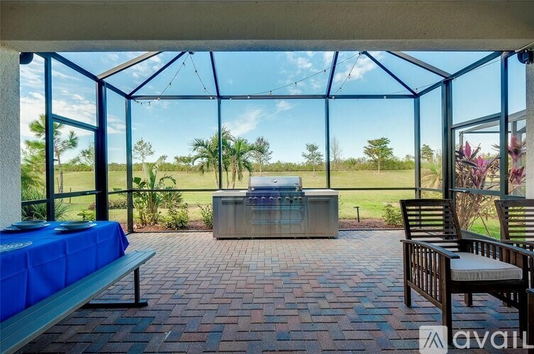 A patio with a table and chairs is set up with a view of the outdoors.