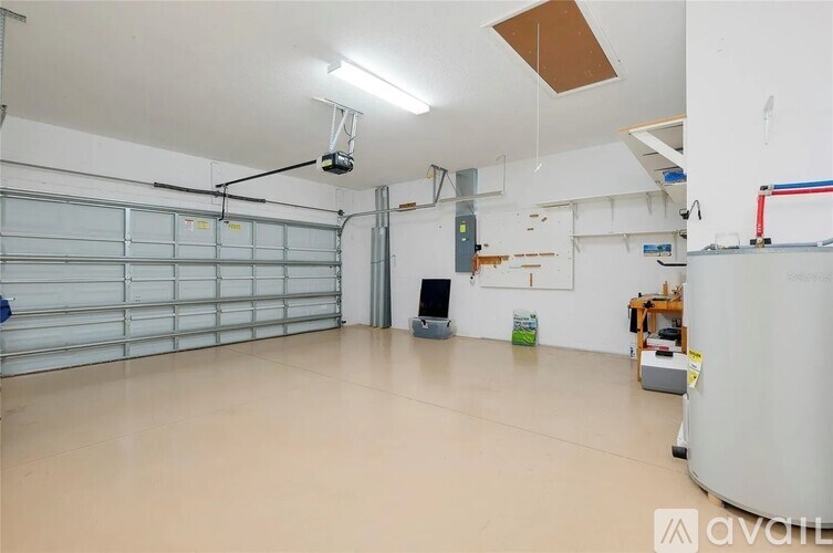A spacious garage with a closed white door and a grey door.