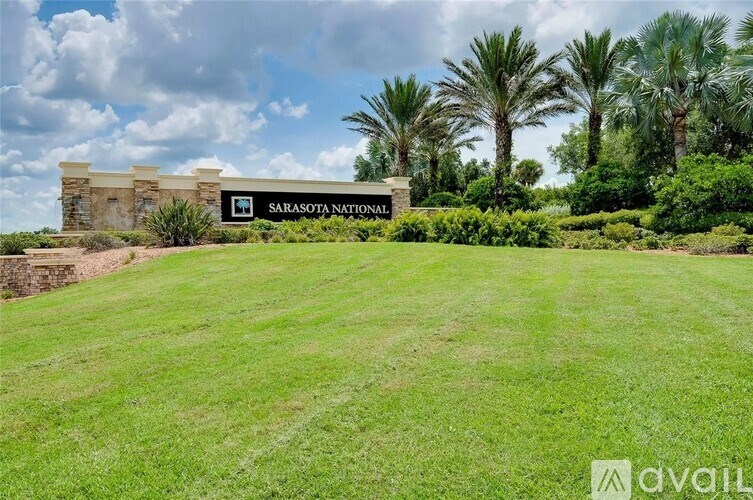 A sign that says Sarasota National in front of a building.