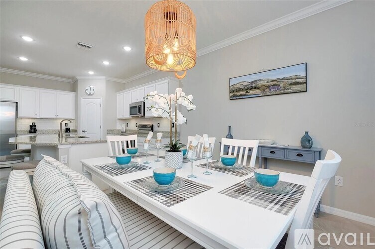 A dining room with a white table and blue bowls.