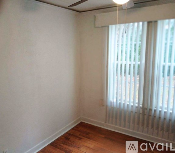 A room with wooden floors and white walls.