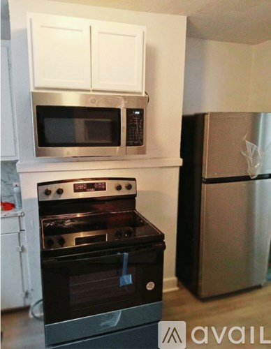 A black stove and microwave in a kitchen.