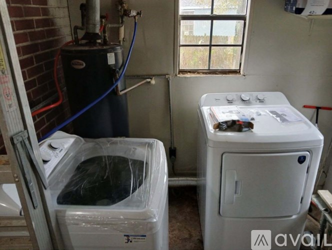 A room with a washing machine and a dryer.