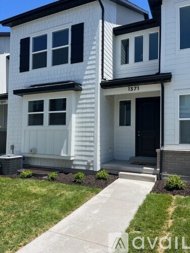 A white house with black trim and a black door.