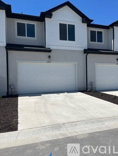 A two-story house with a white garage door.