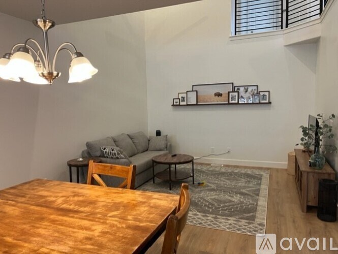 A dining room with a wooden table and chairs.