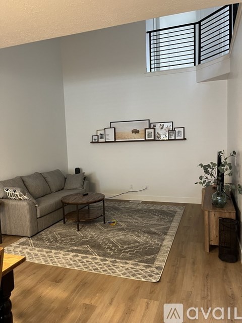 A living room with a grey couch and a coffee table.