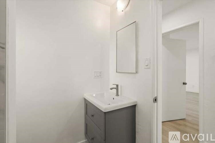 A bathroom with a sink and mirror.