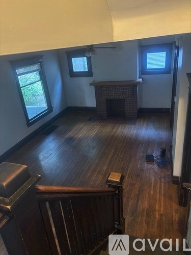 A room with wooden floors and a fireplace.