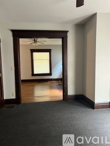 A room with a ceiling fan and a window.