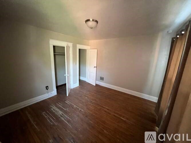 A room with wooden floors and white walls.