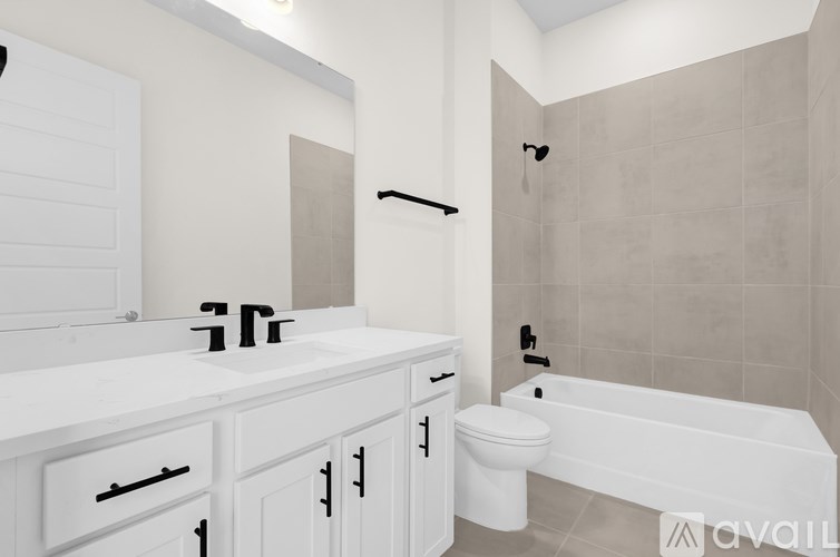 A white bathroom with a sink, toilet, and bathtub.