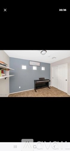 A room with a piano and a wall-mounted shelf.