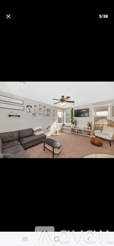 A living room with a grey sofa and a coffee table.