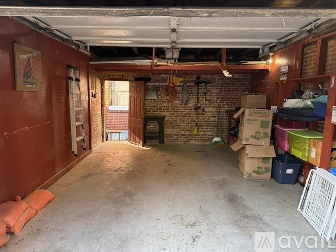 A room with a brick wall and a ladder.