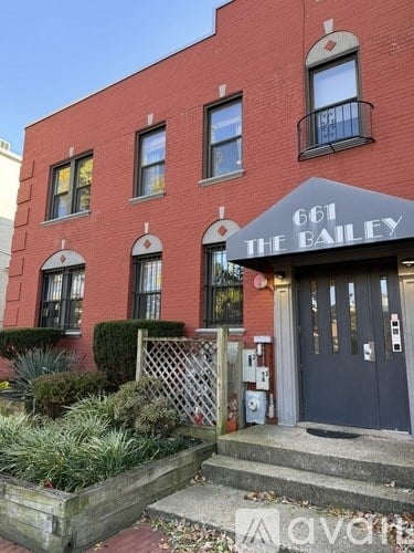 The front of a red building with the number 661 and the name "The Bailey" on it.