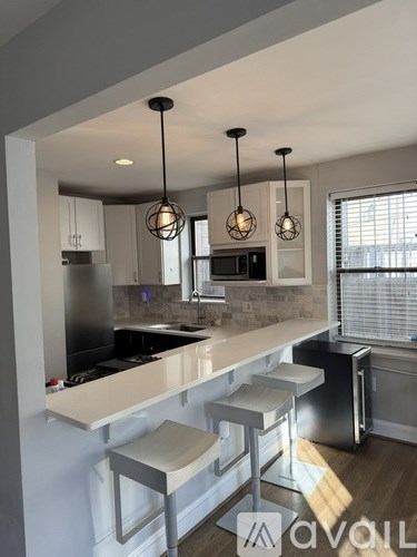 A kitchen with a white countertop and stainless steel appliances.