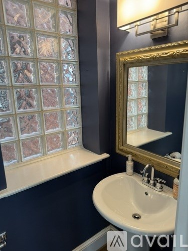 A bathroom with a sink and a mirror.