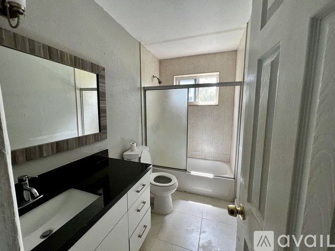 A bathroom with a sink, toilet, and shower.