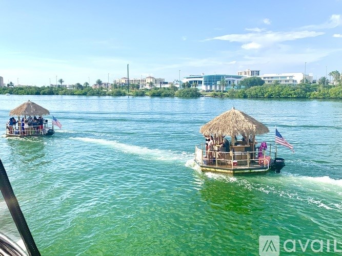 A boat with a thatched roof is sailing on the water.