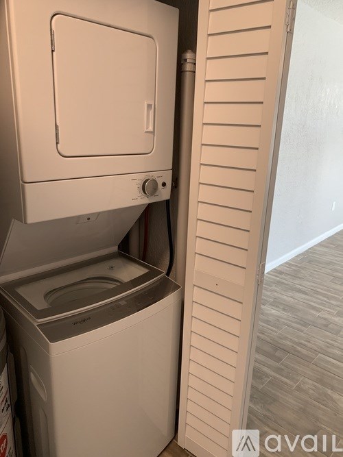 A white washing machine is in a small room.