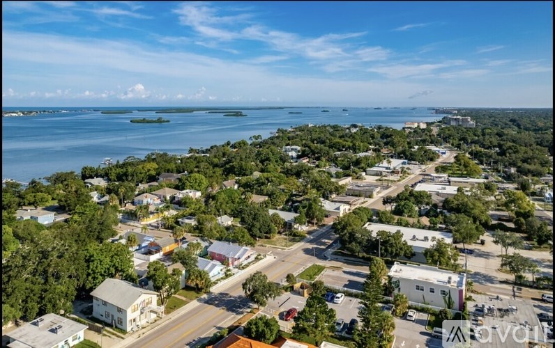 A small town with a large body of water in the background.
