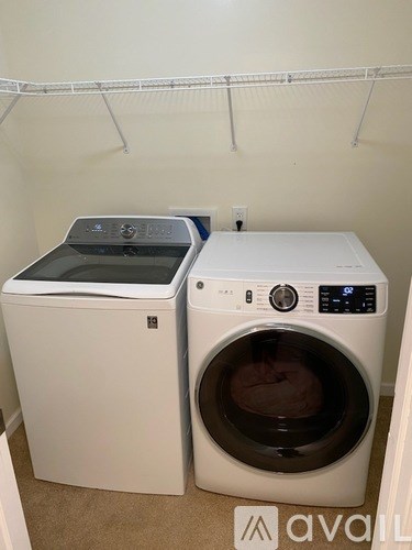A white dryer and washer sitting next to each other.