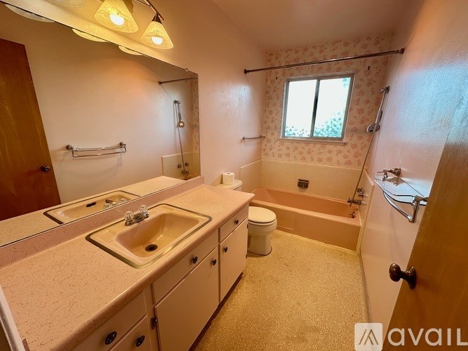 A bathroom with a sink, toilet, and bathtub.
