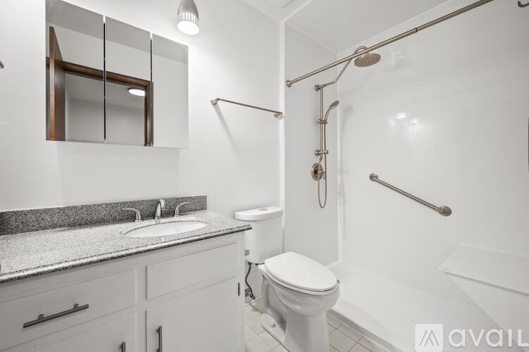 A white bathroom with a toilet, sink, and bathtub.