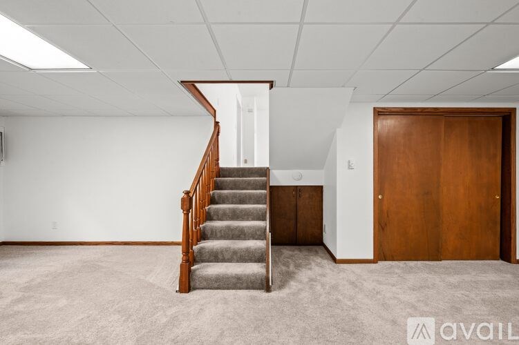 A room with a staircase leading to another room.