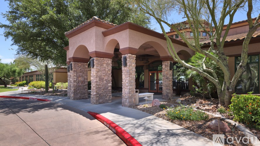 A patio with a table and chairs and a clock on the wall.
