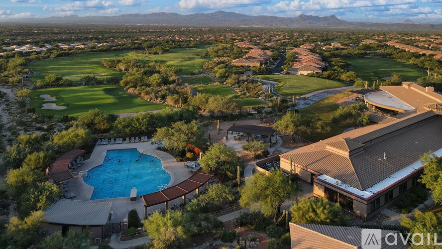 A large building with a pool in front of it.