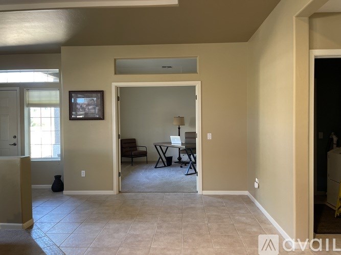 A living room with a couch, chair, and television.
