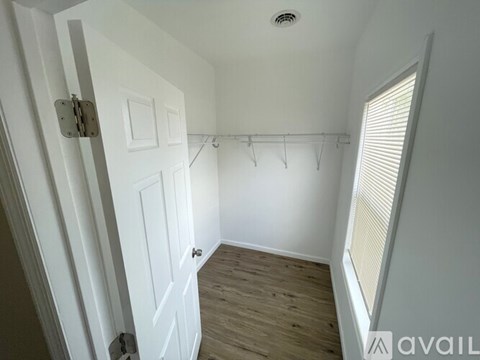 A white door with a hanger rack above it.