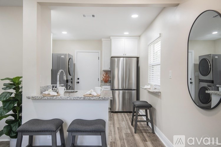 A kitchen with a white countertop and stainless steel appliances.