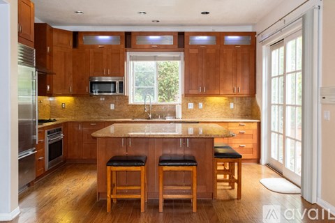 A kitchen with wooden cabinets and a central island.