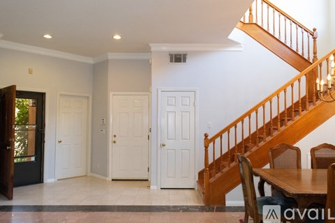 A dining room with a wooden table and chairs.
