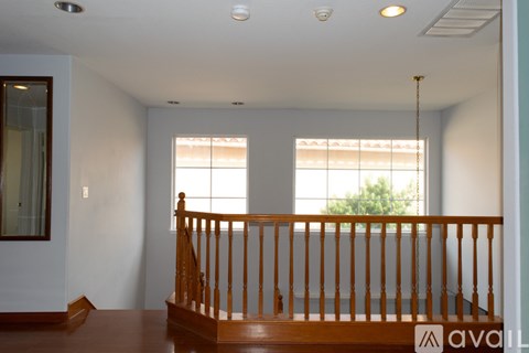 A room with a wooden staircase and a window.