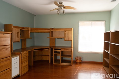 A room with a bunk bed and a desk.