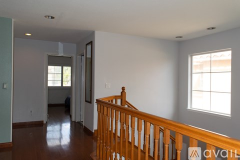 A room with a wooden staircase and a window.