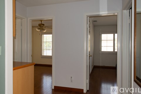 A room with a wooden floor and white walls.