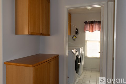 A small laundry room with a washer and dryer.