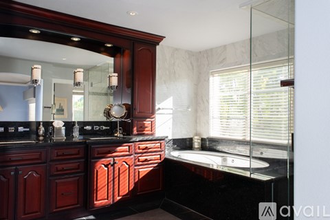 A bathroom with a vanity and a large mirror.