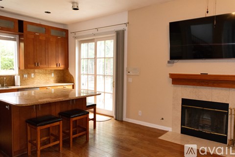 A kitchen with wooden cabinets and a marble countertop.