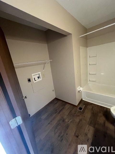 A bathroom with a toilet, sink, and bathtub.