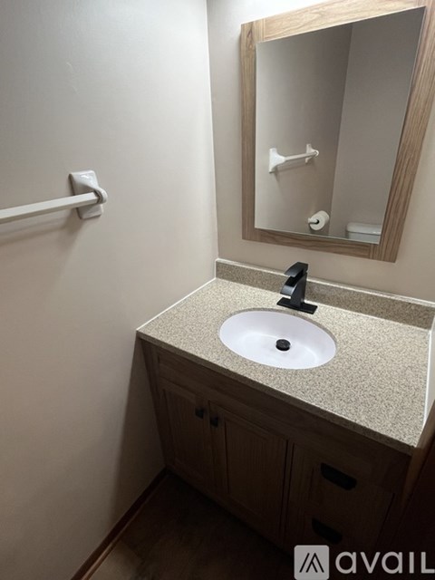 A bathroom with a sink and a mirror.
