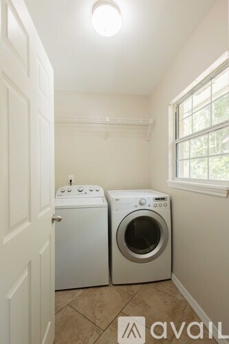 A laundry room with a washer and dryer.