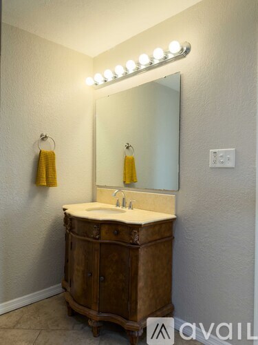 A small house with a white door and a patio with a table and chairs.