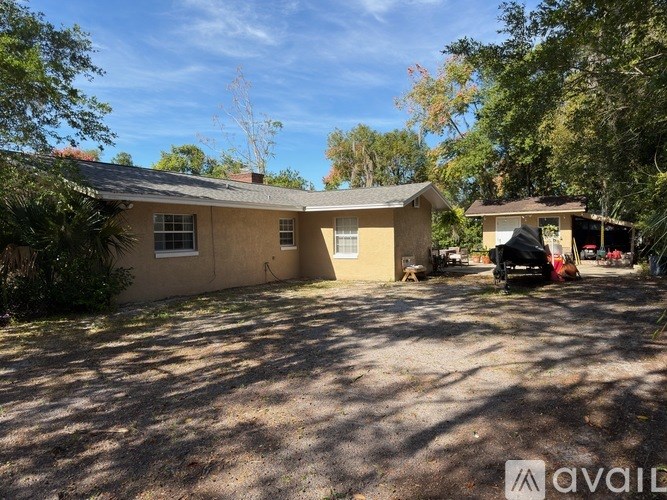A house with a driveway and a car parked in front.