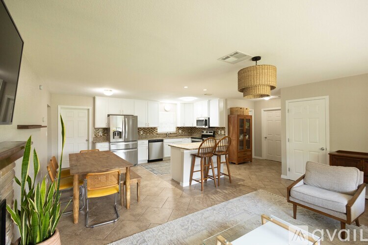 A well-lit kitchen and dining area with a table set for two.